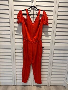 Justfab NWOT Vibrant Orange Jumpsuit with cold shoulders.
